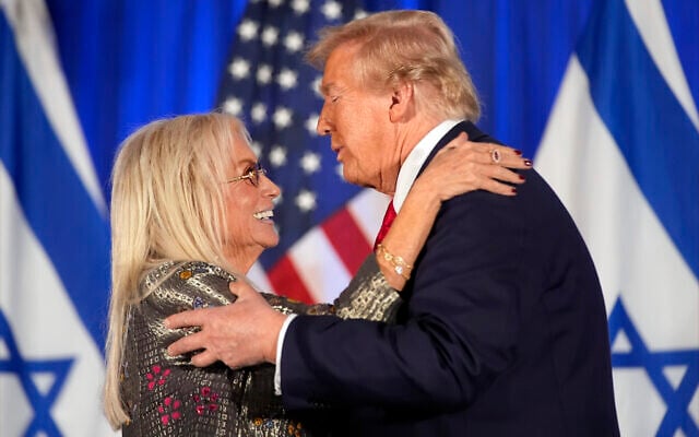 Republican presidential nominee Donald Trump embraces Miriam Adelson at an event marking one year since the October 7 Hamas attack on Israel, October 7, 2024, in Miami. (AP Photo/Alex Brandon)