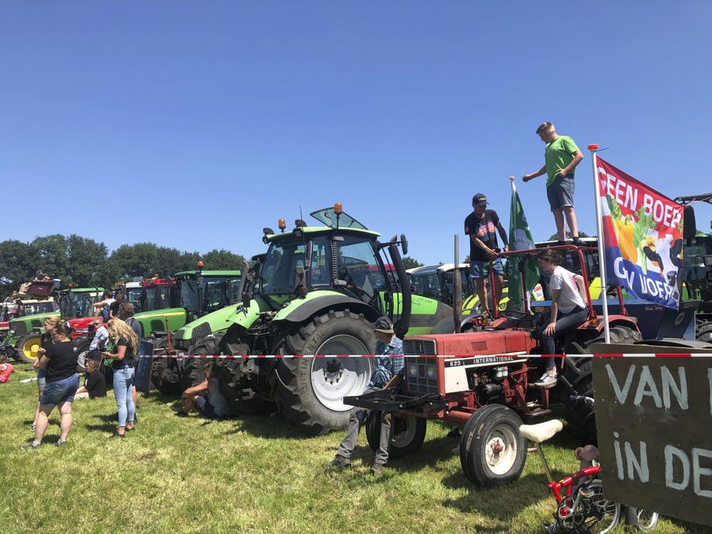 Dutch farmers protesting against the government’s plans to reduce emissions of nitrogen oxide and ammonia gather for a demonstration at Stroe, Netherlands, Wednesday, June 22, 2022. Thousands of farmers drove  their tractors along roads and highways across the Netherlands, heading for a mass protest against the Dutch government’s plans to rein in emissions of nitrogen oxide and ammonia. (AP Photo/Aleksandar Furtula)